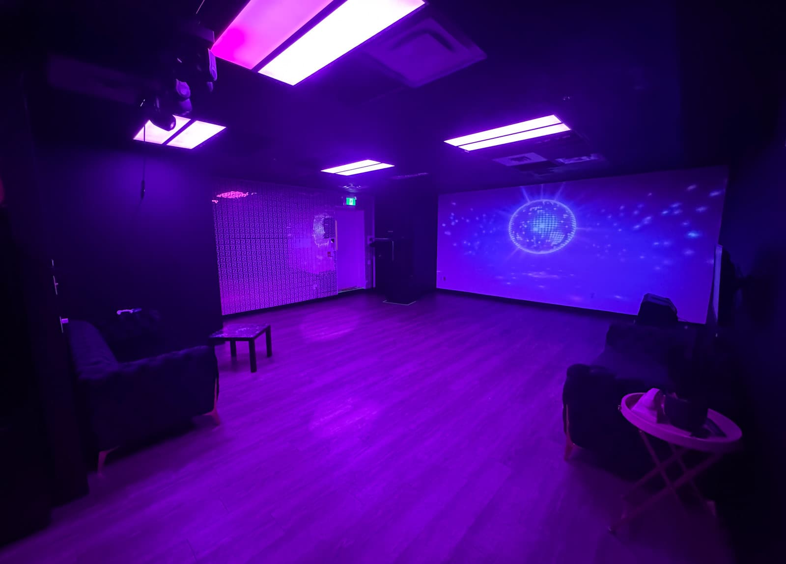 Club Angel room in purple ambient light with disco ball projection